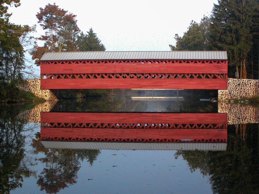 photo shows Sach's Bridge, fire engine red and crossing over water.